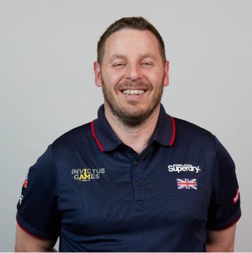 Personnel wears Invictus Games uniform in portrait.